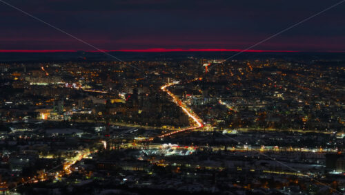 Video - Aerial drone view of Chisinau city covered in snow in the night. Blue hour during winter in Moldova
