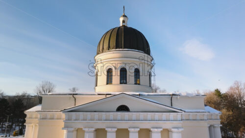 Video - Aerial drone view of the Metropolitan Cathedral of Christ's Nativity. City center covered in snow at sunset in Chisinau, Moldova