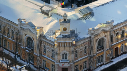 Video - Aerial drone view of Chisinau City Hall covered in snow at sunset. Moldova