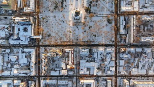 Video - Aerial drone top view of the Bell tower and the Metropolitan Cathedral of Christ's Nativity. City center covered in snow at sunset in Chisinau, Moldova