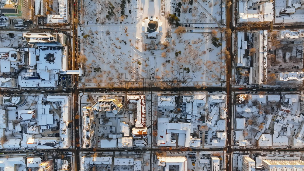 Video - Aerial drone top view of the Bell tower and the Metropolitan Cathedral of Christ's Nativity. City center covered in snow at sunset in Chisinau, Moldova