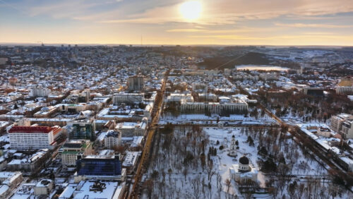 Video - Aerial drone view of Chisinau city center, covered in snow at sunset. Winter in Moldova