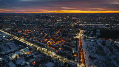 Video - Aerial drone view of Chisinau city covered in snow at sunset, blue hour. Winter in Moldova
