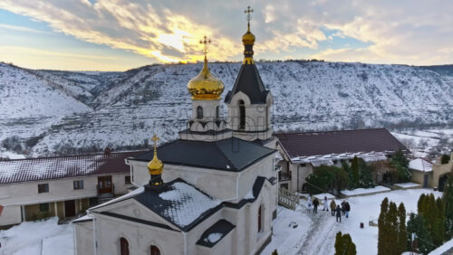 Video - Aerial drone view of the Old Orhei covered in snow at sunrise. Monastery located on a hill in Moldova