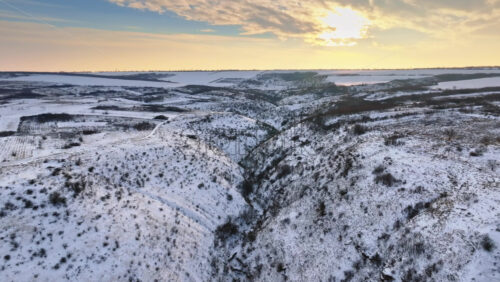 Video - Aerial drone view of the Old Orhei covered in snow at sunrise. Hills during winter in Moldova