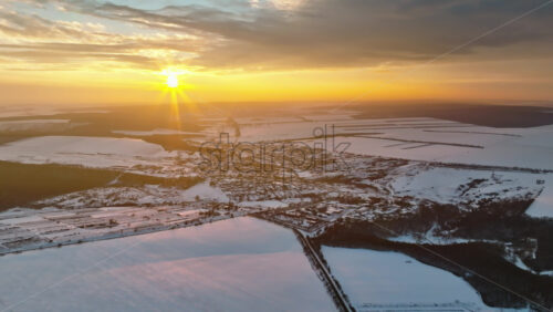 Video - Aerial drone view of Butuceni village covered in snow at sunrise. Fields in Old Orhei during winter in Moldova