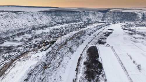 Video - Aerial drone view of the Old Orhei covered in snow at sunrise. Monastery located on a hill in Moldova