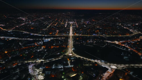 Video - Aerial drone view of Chisinau city covered in snow in the night. Blue hour during winter in Moldova