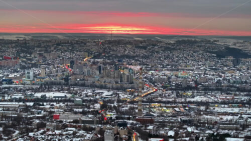 Video - Aerial drone view of Chisinau city covered in snow at sunset. Winter in Moldova