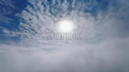 Video - Aerial drone view of the sky with clouds and bright sun