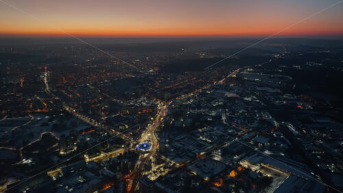Video - Aerial drone view of Chisinau city covered in snow with moving traffic at sunset. Winter in Moldova