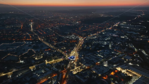 Video - Aerial drone view of Chisinau city covered in snow with moving traffic at sunset. Winter in Moldova