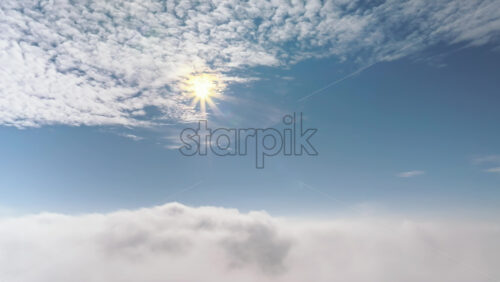 Video - Aerial drone view of the sky with clouds and bright sun