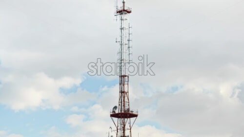Video - Aerial drone view of the radio transmission tower in the daylight