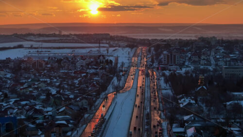 Video - Aerial drone view of Chisinau city covered in snow at sunset. Moving traffic during winter in Moldova