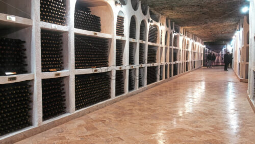 Video - CRICOVA, MOLDOVA - APRIL 6, 2021: Racks with bottles of wine in storage at the Cricova winery, Moldova. Walking visitors