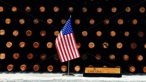 Video - CRICOVA, MOLDOVA - APRIL 6, 2021: Rack with bottles of wine, american flag and name sign in storage at the winery