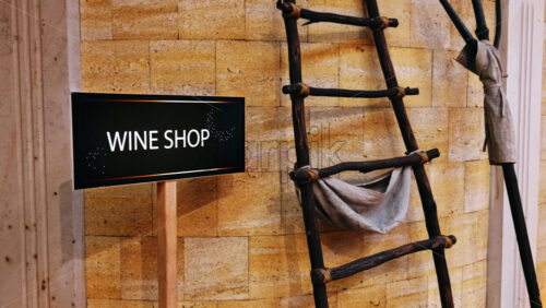Video - Wine shop sign with wooden hand-made instruments near the wall