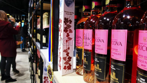 Video - CRICOVA, MOLDOVA - APRIL 6, 2021: Wine and champagne bottles on the racks in the winery. Visitors