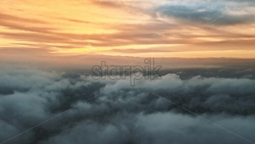 Video - Aerial drone view above the clouds with buildings visible through, Chisinau, Moldova