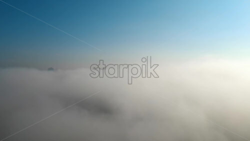 Video - Aerial drone view above the clouds with buildings visible through, Chisinau, Moldova