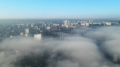 Video - Aerial drone view above the clouds with buildings visible through, Chisinau, Moldova
