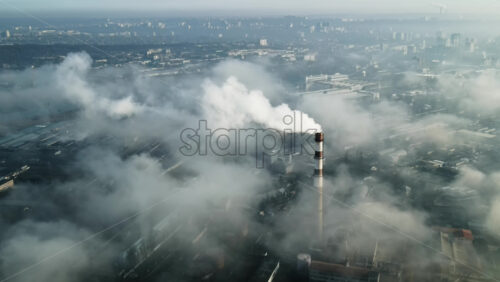 Video - Aerial drone view of Chisinau. Thermal station with smoke coming out of the tube. Buildings, roads. Low clouds. Moldova