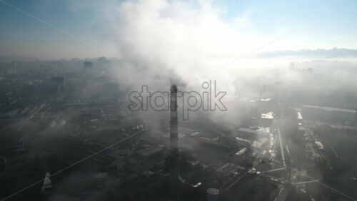 Video - Aerial drone view of Chisinau. Thermal station with smoke coming out of the tube. Buildings, roads. Fog in the air. Moldova