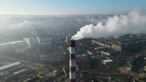 Video - Aerial drone view of Chisinau. Thermal station with smoke coming out of the tube. Buildings, roads. Fog in the air. Moldova