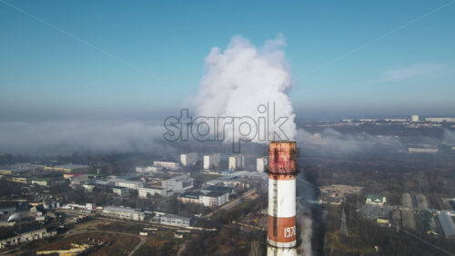 Video - Aerial drone view of Chisinau. Thermal station with smoke coming out of the tube. Buildings, roads. Fog in the air. Moldova