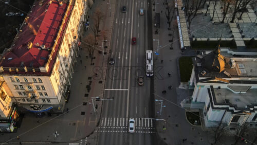 Video - CHISINAU, MOLDOVA - JANUARY 1, 2021: Aerial drone panorama view of downtown, street with multiple buildings, road with moving cars and bare trees