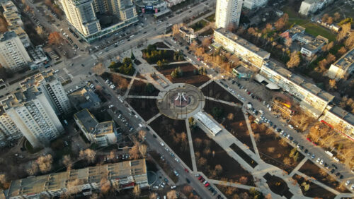 Video - CHISINAU, MOLDOVA - JANUARY 15, 2021: Aerial drone view of a Afghan memorial park in Chisinau, Moldova. Walking people, roads with cars, memorial, trees and buildings. Winter