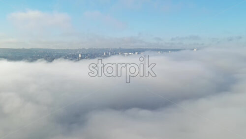 Video - Aerial drone view above the clouds with buildings visible through, Chisinau, Moldova