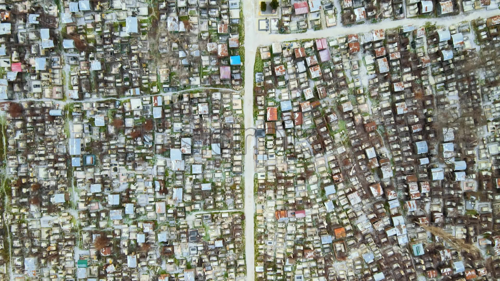 Video - Aerial drone view of a cemetery in Chisinau, Moldova. Multiple graves, crypts, walkway, Cloudy weather, bare trees, winter