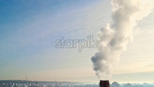 Video - Aerial drone view of Chisinau. Thermal station with smoke coming out of the tube. Buildings, roads and bare trees. Good weather. Moldova