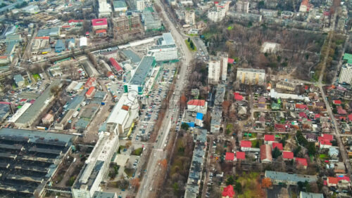 Video - Aerial drone view of Chisinau. Panorama view of multiple buildings, roads with moving cars and bare trees. Moldova