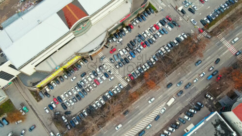 Video - Aerial drone view of Chisinau. View of a street road with moving cars, parking and bare trees along it. Moldova