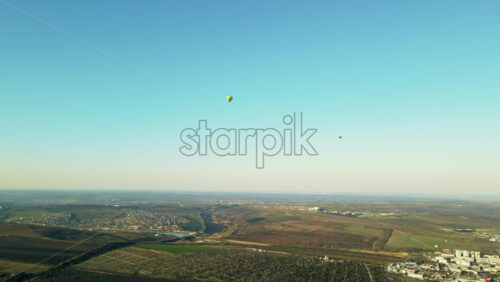 Video - Aerial drone view of two hot air baloons flying above the land of Moldova, hills, clean sky