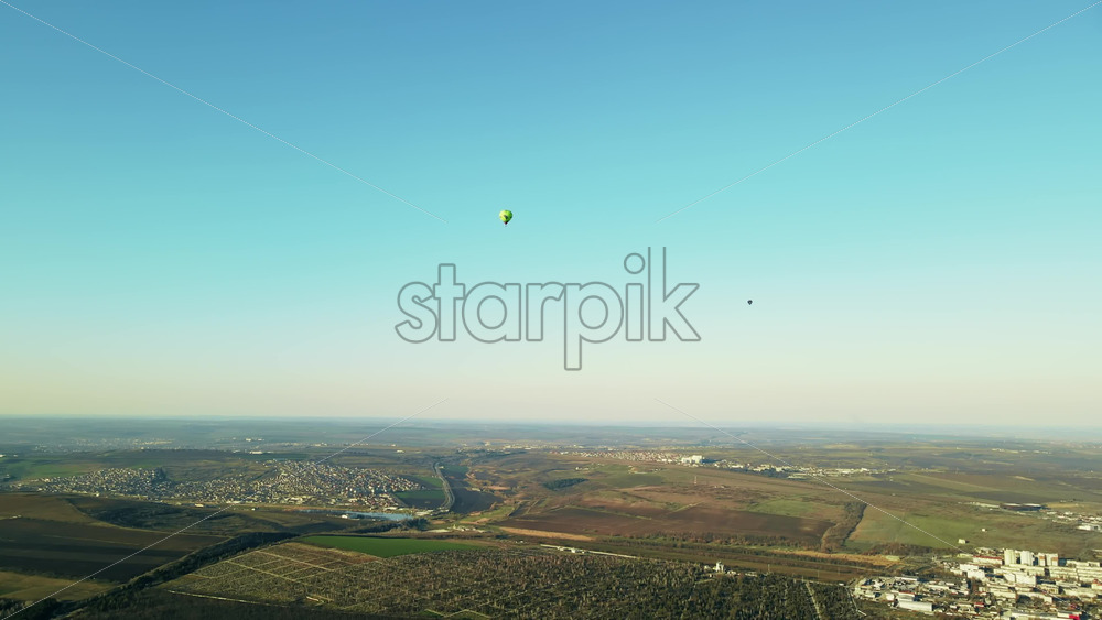 Video - Aerial drone view of two hot air baloons flying above the land of Moldova, hills, clean sky