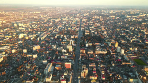 Video - Aerial drone view of Chisinau downtown at sunset. Multiple buildings, trees, parks, road with mooving cars. Moldova