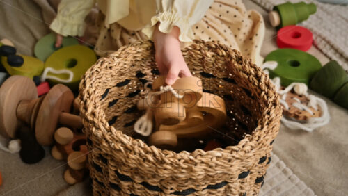 Video - Little girl's hands put wooden toys in the basket. Ecological and sustainability concept