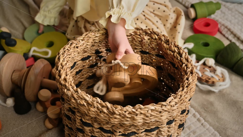Video - Little girl's hands put wooden toys in the basket. Ecological and sustainability concept