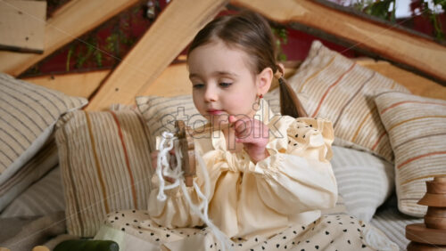 Video - Little girl playing with a wooden lacing sheep. Ecological and sustainability concept