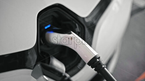Video - Plugged charger into an electric car, blue flickering light in the socket