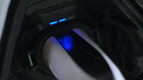 Video - Plugged charger into an electric car, blue flickering light in the socket
