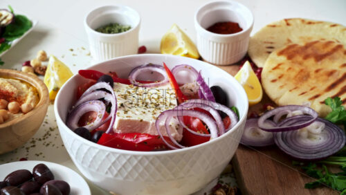 Video - Close-up view of a table full of healthy national food in dishes. Sliced vegetables, salads and appetizers