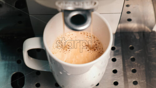 Video - Coffee machine pouring coffee with into a cup