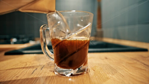 Video - Pouring hot water over instant coffee on the kitchen table