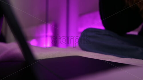 Video - Young ginger hairl girl using her tablet in the bedroom and drinking coffee. Working from home. Close up