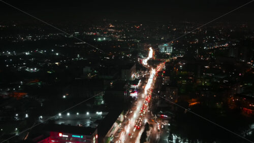 Video - Hyperlapse of Chisinau at night, drone view. Multiple buildings, roads with moving cars, night city illumination. Moldova